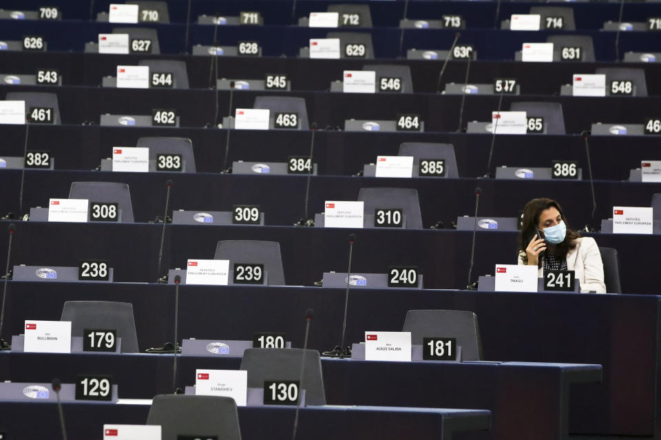 An MEP waits in the plenary for the session to begin at the European Parliament in Strasbourg, France, Wednesday, Sept. 15, 2021. The European Union announced Wednesday it is committing 200 million more coronavirus vaccine doses to Africa to help curb the COVID-19 pandemic on a global scale. (Yves Herman, Pool via AP)