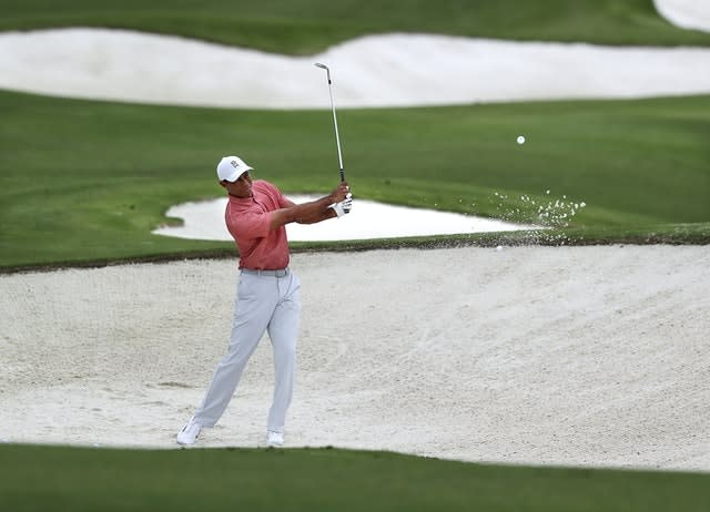 Tiger Woods practices on his sand shots on the practice range at Augusta National