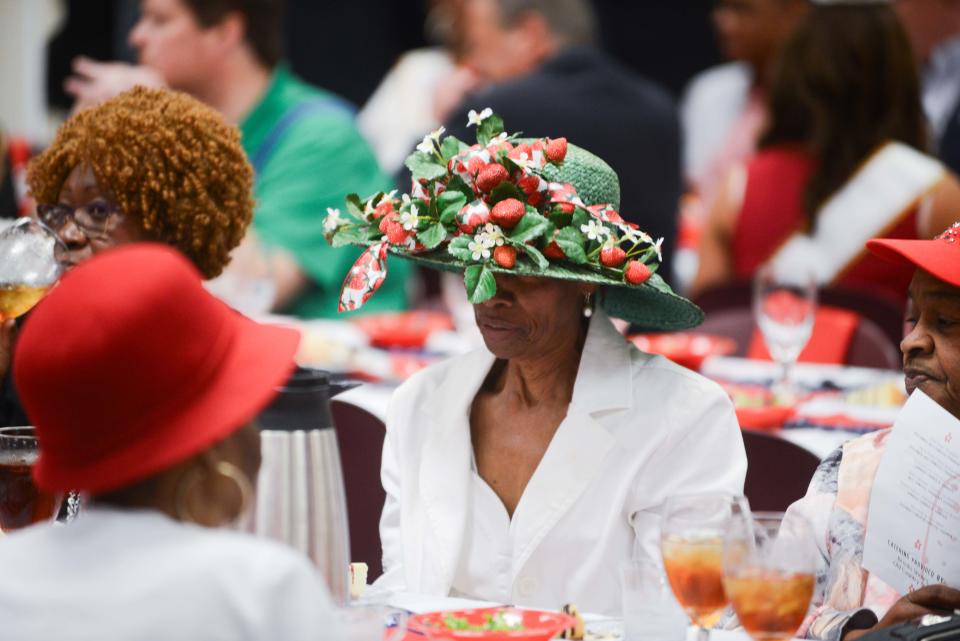 An attendee dons a strawberry-themed hat during the 86th annual West Tennessee Strawberry Festival Governor's Luncheon in Humboldt, Tenn., on Friday, May 10, 2024.