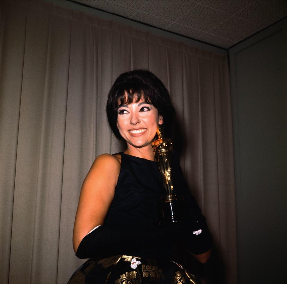 rita moreno smiling as she holds her academy award