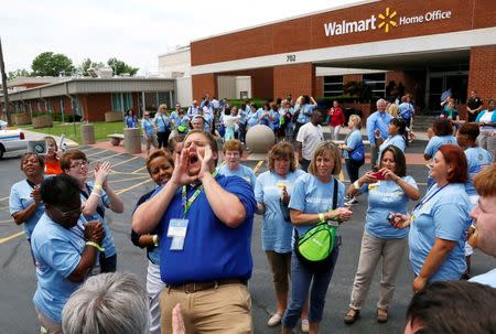 Jared Lawrence leads employees of Wal-Mart Stores, Inc. in a company chant outside company headquarters before a Walmart employee tour in Bentonville, Arkansas, in this file photo taken June 5, 2013. REUTERS/Rick Wilking/Files