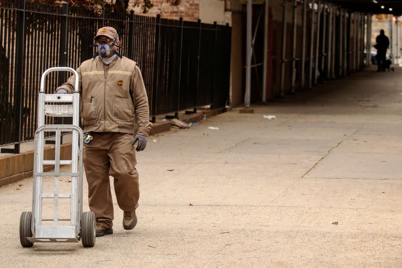 A UPS delivery driver wears a mask as he walks down the street during an ongoing outbreak of the coronavirus disease (COVID-19) in the Brooklyn borough of New York