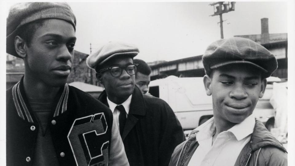 Lawrence-Hilton Jacobs, Glynn Turman and Corin Rogers stand together outside in a scene in "Cooley High."