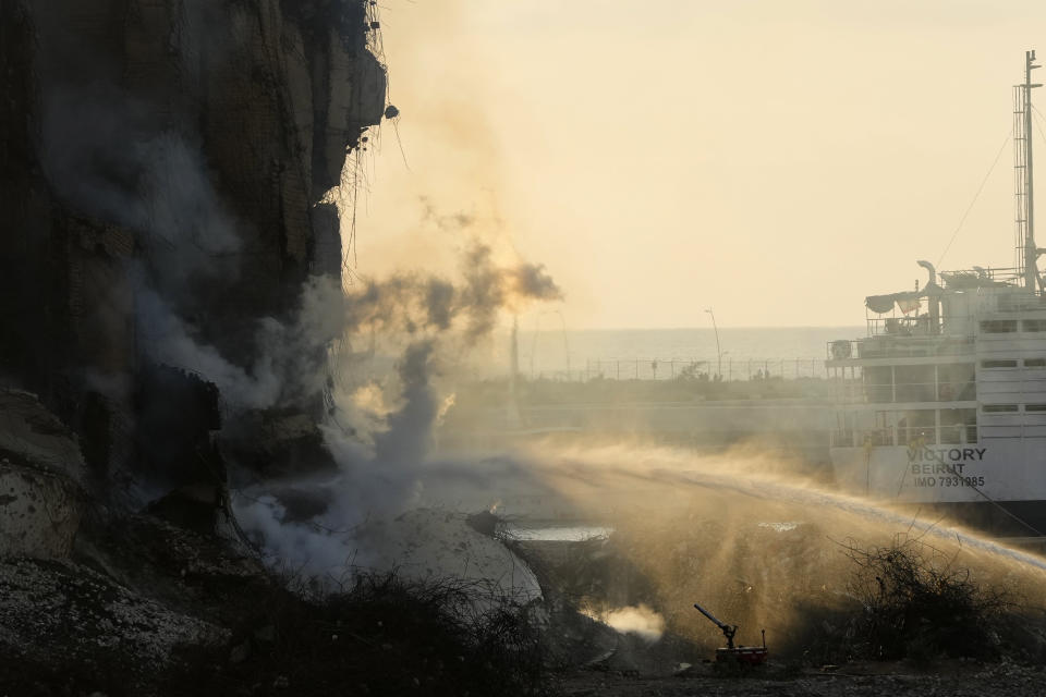 Firefighters extinguish a fire at the silos in the north block of the Beirut Port in Beirut, Lebanon, Thursday, July 21, 2022. The silos were destroyed by a massive explosion in 2020 and the structure might have caught on fire due to fermented grains. (AP Photo/Hassan Ammar)