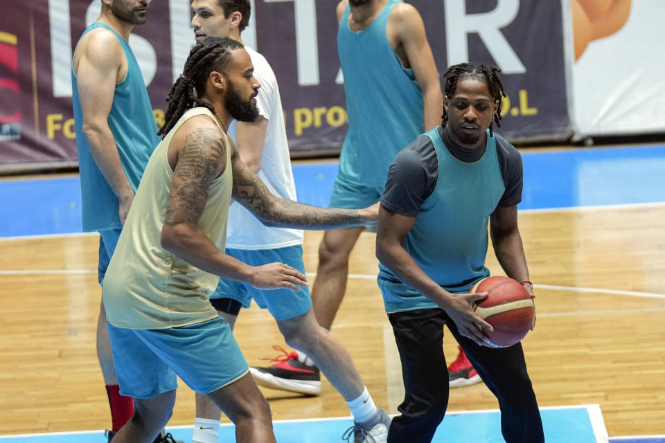 Isaac Banks, left, and, Uchenna Iroegbu American basketball players. with the Hashed al-Shaabi - the Popular Mobilization Forces - in the Iraqi Basketball Super League, take part in a team practice in Baghdad, Iraq, Thursday, March 21, 2024. U.S. players are in high demand on Iraqi basketball teams, even those whose owners have a tense relationship with Washington. (AP Photo/Hadi Mizban)