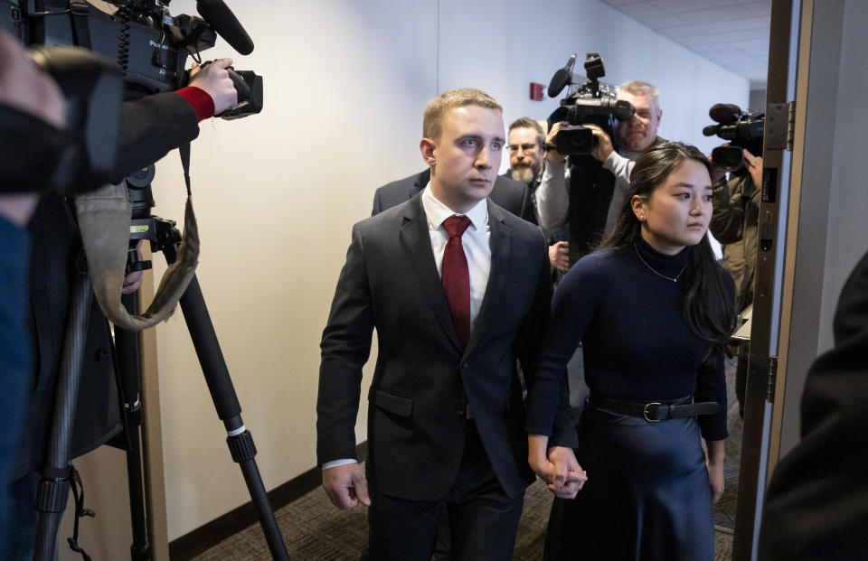 Trooper Ryan Londregan walks hand-in-hand with his wife to his first court appearance to answer to murder and manslaughter charges in the killing of Ricky Cobb II during a traffic stop last summer on Monday, Jan. 29, 2024 at the Hennepin Public Safety Facility in Minneapolis, Minn. (Renée Jones Schneider/Star Tribune via AP)