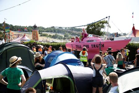 Protestors affiliated with Extinction Rebellion take part in a procession during Glastonbury Festival at Worthy farm in Somerset