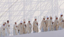 <p>Pope Francis, bottom left, and priests arrive for a Mass in Genoa, Italy, Saturday, May 27, 2017. Pope Francis is on a one-day visit to the northern Italian port city of Genoa to meet with workers, poor and homeless people, refugees and prisoners. (Photo: Antonio Calanni/AP) </p>