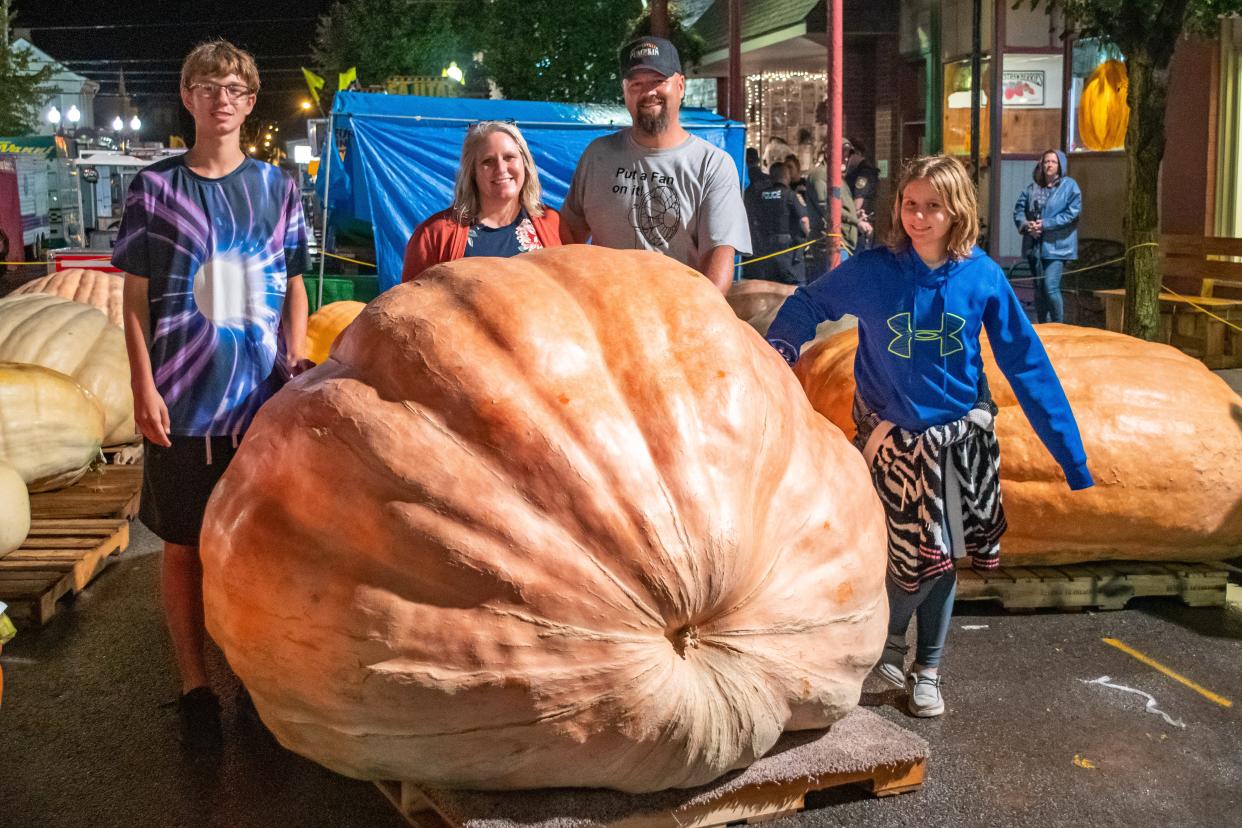 The Theil family with their 2021 Barnesville Pumpkin Festival King Pumpkin. Weighing 2,195 pounds, the pumpkin also set a new state record.