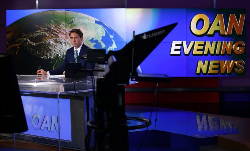 K.C. Alfred  U-T Patrick Hussion waits during a break while hosting an evening news segment on One America News Network.