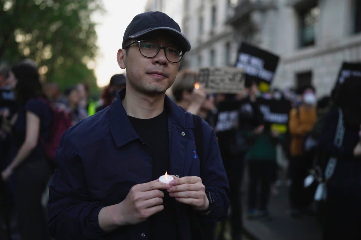 Hong Kong activist Nathan Law attends a candlelight vigil outside the Chinese embassy in London on 4 June (AP)