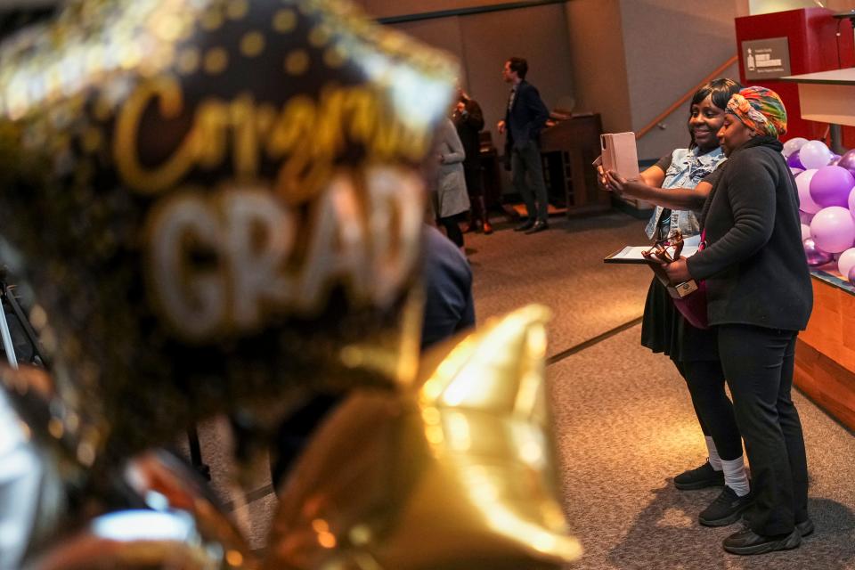 Renee Massey takes a photo with her daughter Leonna Jefferson, one of the five graduates in the first graduation ceremony Friday, March 1, 2024, of Franklin County Common Pleas Court's mental health docket called RISE Court.