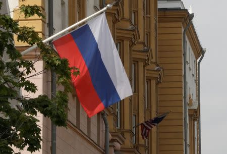 A Russian flag flies in front of the U.S. embassy building in Moscow, Russia, July 28, 2017. REUTERS/Tatyana Makeyeva