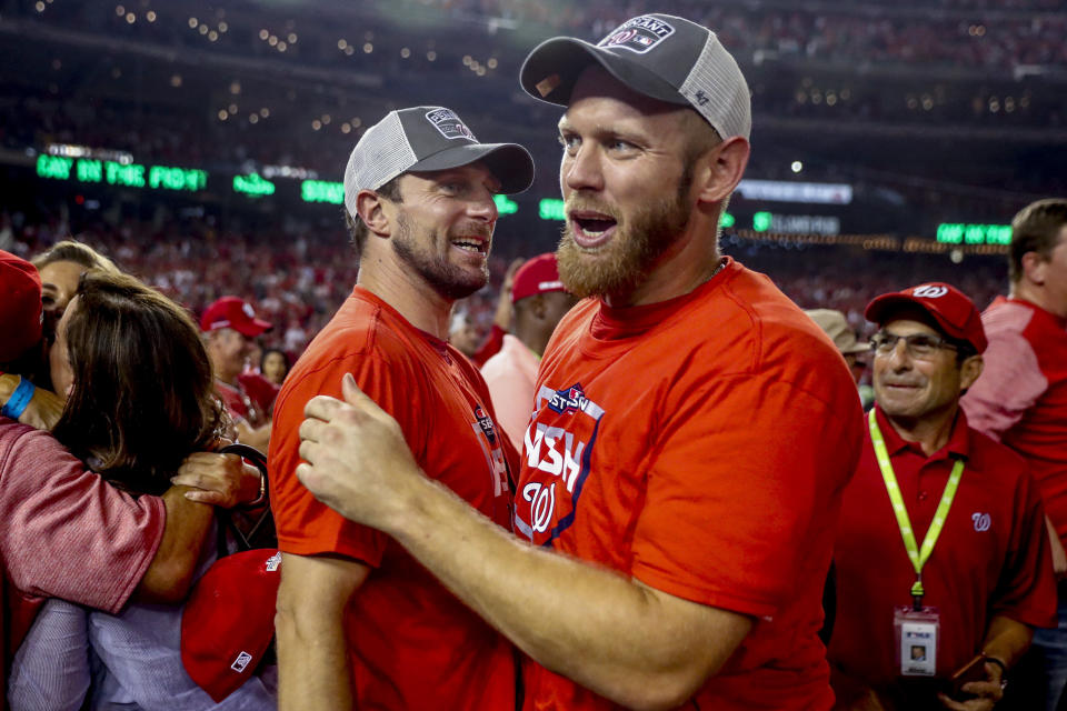 FILE - Washington Nationals pitchers Max Scherzer, left, and Stephen Strasburg hug after the Washington Nationals defeated the Milwaukee Brewers 4-3 in a National League wild-card baseball game at Nationals Park, Tuesday, Oct. 1, 2019, in Washington. Nationals pitcher Stephen Strasburg has decided to announce his retirement, ending a career that began as a No. 1 draft pick, included 2019 World Series MVP honors and was derailed by injuries, according to a person with knowledge of the situation. The person spoke to The Associated Press on condition of anonymity Thursday, Aug. 24, 2023, because Strasburg has not spoken publicly about his plans. (AP Photo/Andrew Harnik, File)