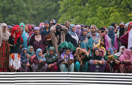 Women watch the body of Zakir Rashid Bhat also known as Zakir Musa, the leader of an al Qaeda affiliated militant group in Kashmir, during his funeral procession in Dadasara village in south Kashmir's Tral May 24, 2019. REUTERS/Danish Ismail