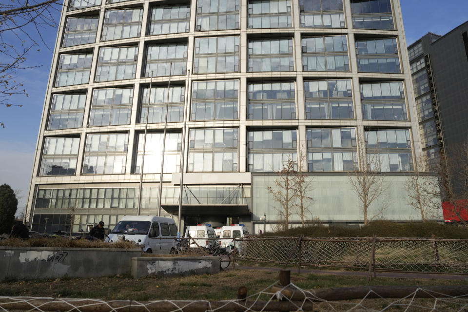 Police vans are seen outside the headquarters of the Zhongzhi Enterprise Group Co. in Beijing, Tuesday, Nov. 28, 2023. A top executive of China Evergrande's electric vehicle company has been detained by police in the latest sign of trouble for the world's most heavily indebted property developer. That followed news over the weekend that Zhongzhi Enterprise Group, a major shadow bank in China that has lent billions in yuan (dollars) to property developers, filed for bankruptcy liquidation after it was unable to pay its debts. (AP Photo/Ng Han Guan)