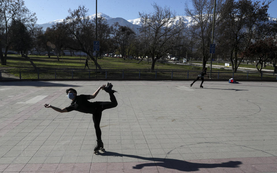 Skating athletes Jean Carlos Morales and María Francisca Ortega train in Las Condes borough of Santiago Chile, Tuesday, July 28, 2020. As the Chilean government put a roadmap in place to roll back quarantine measures, various neighborhoods in the capital started on Tuesday to ease the COVID-19 lockdown. (AP Photo/Esteban Felix)