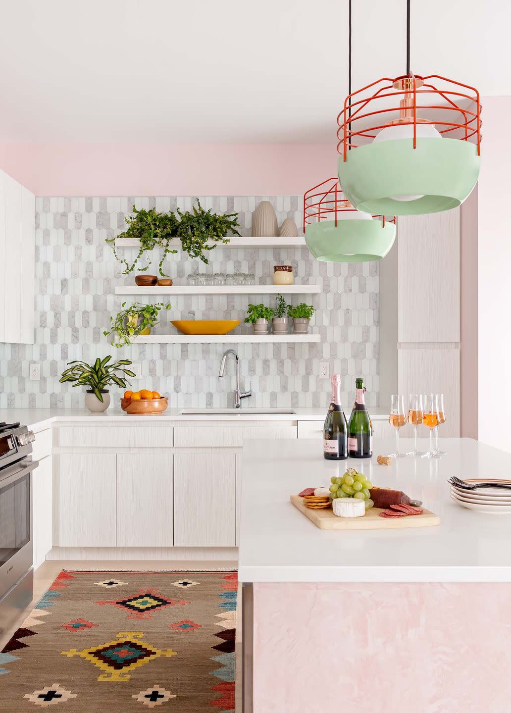 kitchen with pink island and pink walls