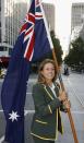 MELBOURNE, AUSTRALIA - MARCH 13: Jane Saville poses with the Australian flag after being announced as the Australian Team's Flag Bearer for the 2006 Melbourne Commonwealth Games at Collins St, March 13, 2006 in Melbourne, Australia. (Photo by Quinn Rooney/Getty Images)
