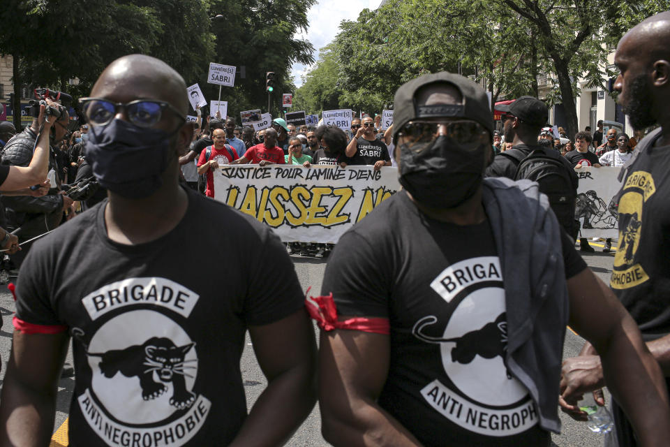 People march during a protest in Paris, Saturday, June 20, 2020. Multiple protests are taking place in France on Saturday against police brutality and racial injustice, amid weeks of global anger unleashed by George Floyd's death in the US. Banner reads "Let us breathe". (AP Photo/Rafael Yaghobzadeh)