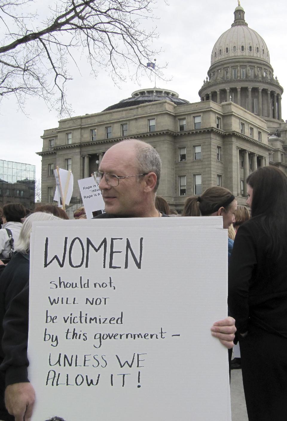 Protester Vernon Ray demonstrates against legislation requiring women seeking an abortion to undergo ultrasound outside of the Idaho Capitol on Wednesday, March 21, 2012 in Boise. Protesters gathered as an anti-abortion group held a live ultrasound exhibition inside the building. (AP Photo/Jessie L. Bonner)