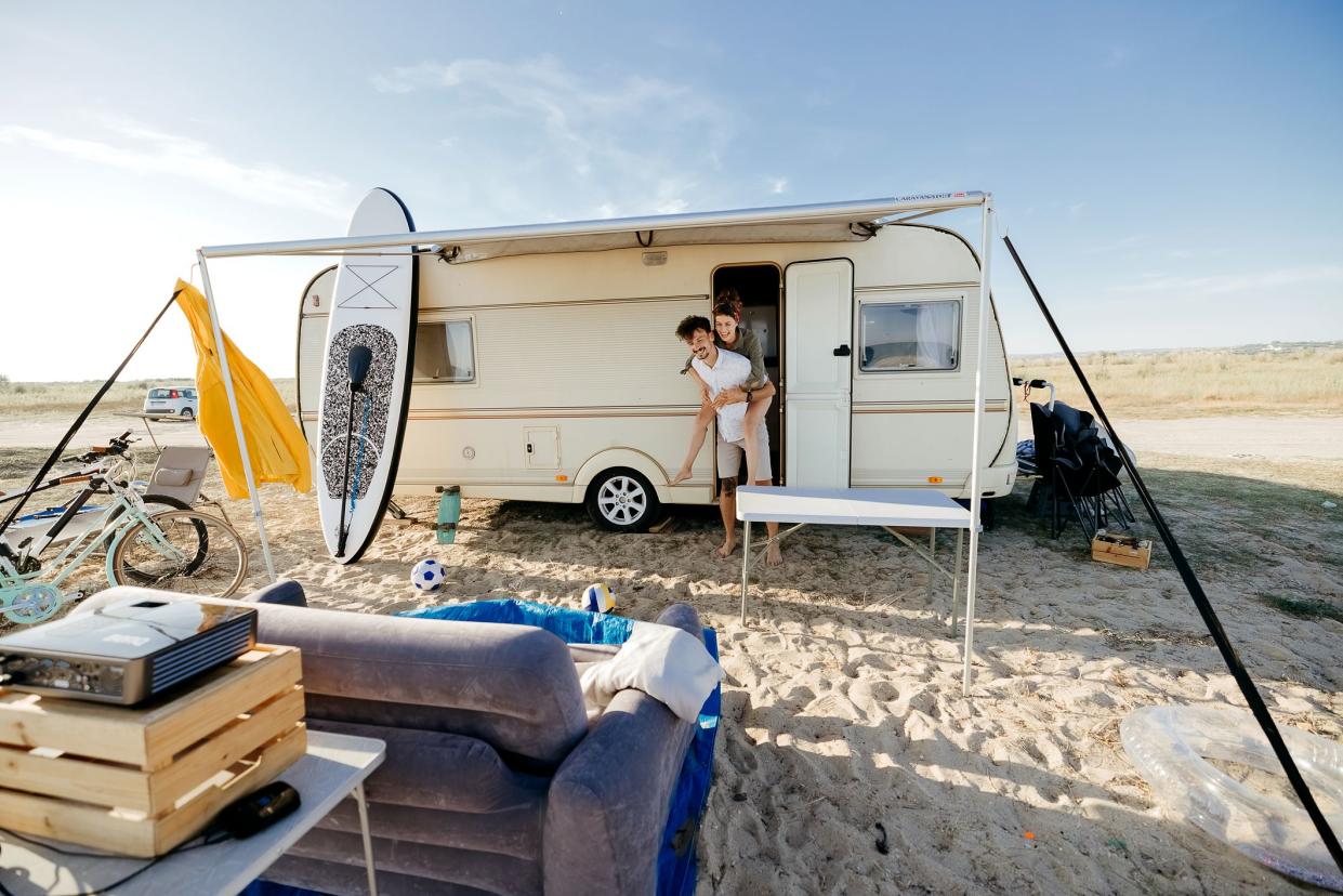 Couple near the camper van parked near the sea