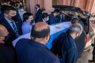 Pallbearers carry the casket of soccer legend Diego Maradona after a public viewing at the presidential palace Casa Rosada, in Buenos Aires