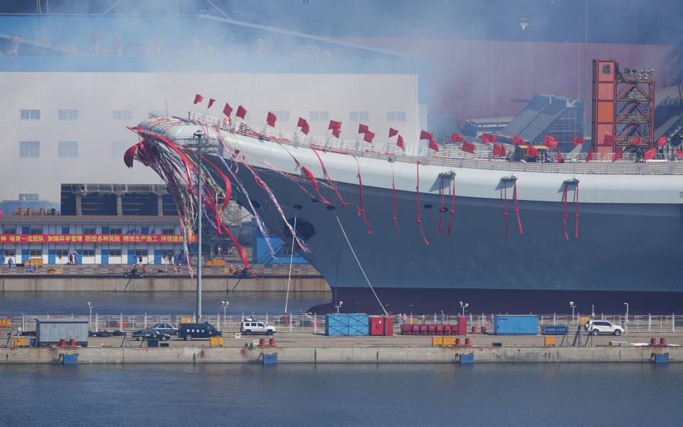 China's first domestically built aircraft carrier is seen during its launching ceremony in Dalian - Credit: REUTERS
