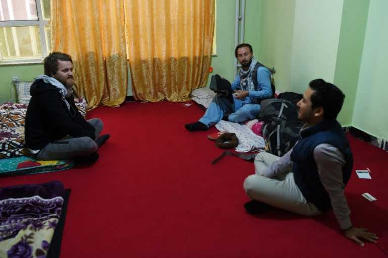 Afghan Couchsurfing host Naser Majidi (R), 27, talks with his guests Norwegian tourist Jorn Bjorn Augestad (L), 29, and Dutch tourist Ciaran Barr, 24, at a house in Kabul