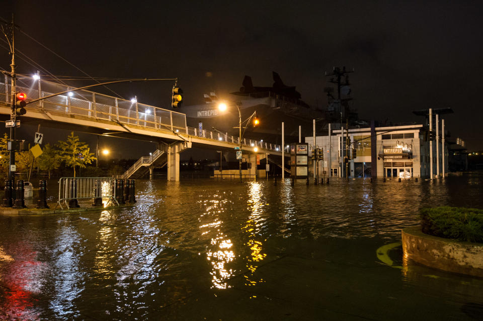 This photo provided by Dylan Patrick shows flooding along the Westside Highway near the USS Intrepid, background center, as Sandy moves through the area Monday, Oct. 29, 2012 in New York. Much of New York was plunged into darkness Monday by a superstorm that overflowed the city's historic waterfront, flooded the financial district and subway tunnels and cut power to nearly a million people. (AP Photo/Dylan Patrick) MANDATORY CREDIT: DYLAN PATRICK