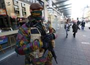 Belgian soldiers patrol in central Brussels as police searched the area during a continued high level of security following the recent deadly Paris attacks, Belgium, November 23, 2015. REUTERS/Yves Herman