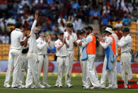 Australia's Nathan Lyon acknowledges the crowd as he celebrates the wicket of India's Wriddhiman Saha with team mates. REUTERS/Danish Siddiqui