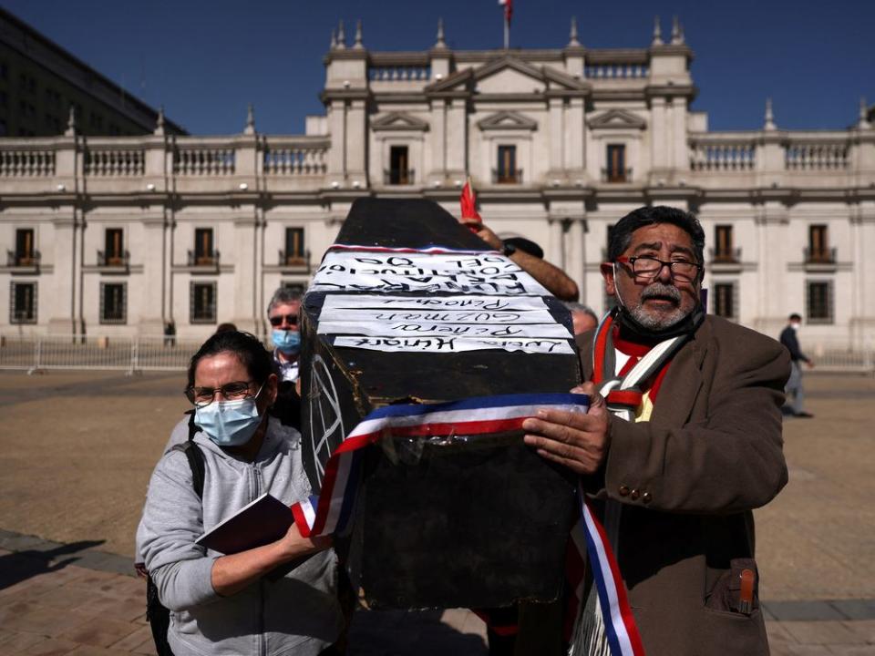  Demonstrators carry a mock-coffin representing the Chilean 80’s constitution.
