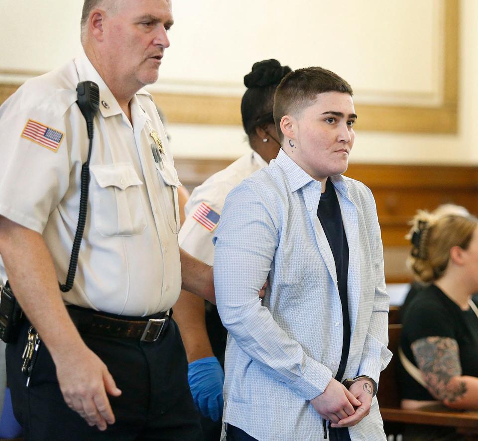 Alyssa Dellamano is escorted into Dedham Superior Court on Thursday, July 27, 2023. She is accused of killing Cameron Nohmy, 24, of Milton, in Quincy in 2020.