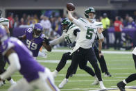 New York Jets quarterback Mike White (5) throws a pass ahead of Minnesota Vikings linebacker Danielle Hunter (99) during the first half of an NFL football game, Sunday, Dec. 4, 2022, in Minneapolis. (AP Photo/Andy Clayton-King)