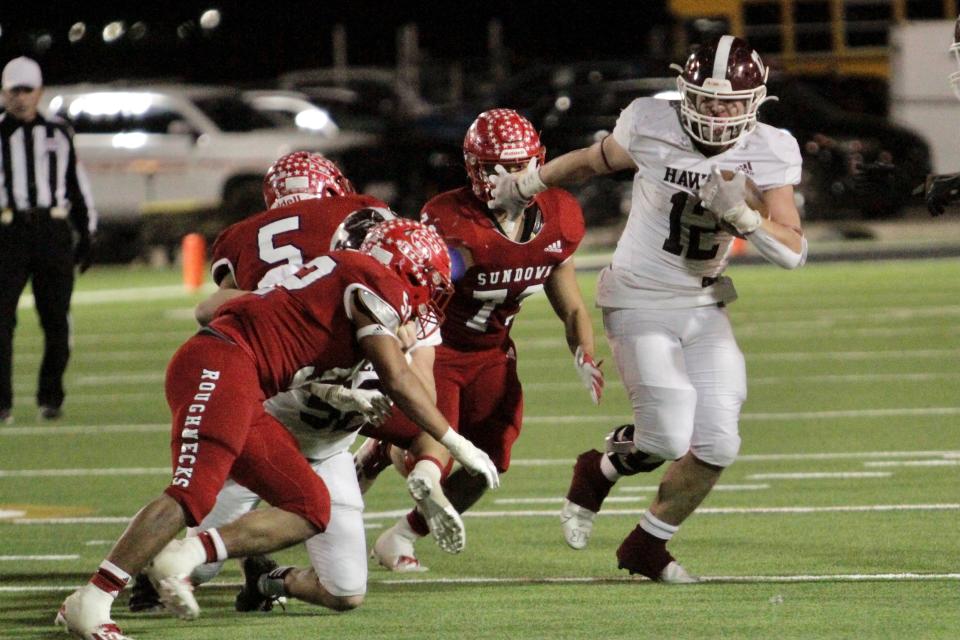 Hawley's Austin Cumpton attempts to surge past a handful of Sundown defenders in their playoff game Nov. 19 in Big Spring.