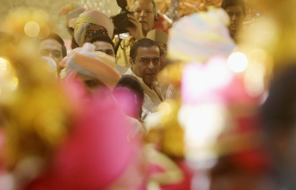 Reliance Industries Chairman Mukesh Ambani waits for the arrival of the groom in Mumbai, India, Wednesday, Dec. 12, 2018. In a season of big Indian weddings, the Wednesday marriage of the scions of two billionaire families might be the biggest of them all. The bride Isha is the Ivy League-educated daughter of industrialist Mukesh Ambani, thought to be India's richest man. The groom Anand Piramal is the son of industrialist Ajay Piramal, thought to be worth $10 billion. (AP Photo/Rajanish Kakade)