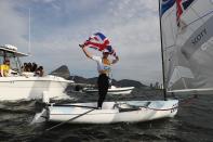 <p>Giles Scott of Great Britain celebrates winning the gold medal in the Finn class on Day 11 of the Rio 2016 Olympic Games at the Marina da Gloria on August 16, 2016 in Rio de Janeiro, Brazil. (Photo by Clive Mason/Getty Images) </p>