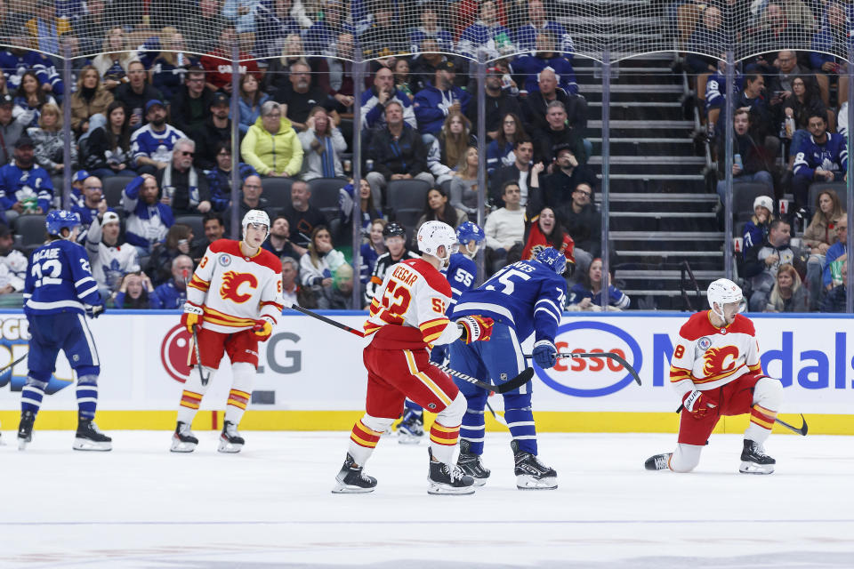 Calgary Flames left wing A.J. Greer, right, celebrates a goal against the Toronto Maple Leafs during the second period of an NHL hockey game Friday, Nov. 10, 2023, in Toronto. (Cole Burston/The Canadian Press via AP)