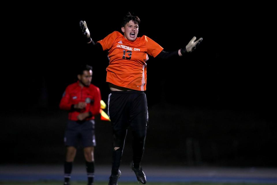 Cathedral City goalkeeper Aldo Carlos (13) gestures towards the crowd after making the first save in an overtime shootout against Wilson Hacienda Heights during their CIF Division 6 soccer quarterfinal in Cathedral City, Calif., on Tuesday, February 13, 2024.