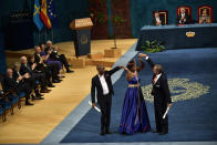 Alvaro Rengifo Abbad, right, Nice Nailantei Leng and Githinji Gitahi, gesture after receiving Princess of Asturias Award Sport from Spain's King Felipe VI at a ceremony in Oviedo, northern Spain, Friday Oct. 19, 2018. (AP Photo/Alvaro Barrientos)