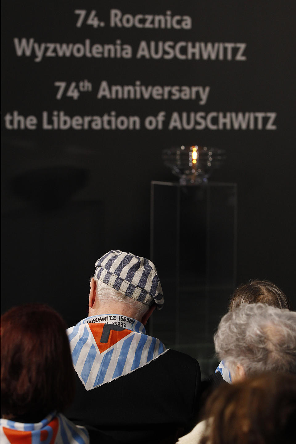 Survivors attend a commemoration event in the so-called "Sauna" building at the former Nazi German concentration and extermination camp Auschwitz II-Birkenau, on International Holocaust Remembrance Day in Oswiecim, Poland, Sunday, Jan. 27, 2019.(AP Photo/Czarek Sokolowski)