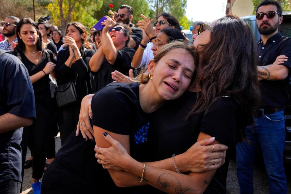 Abeer (centre), the sister of Abdallah, weeps at his funeral (AP)