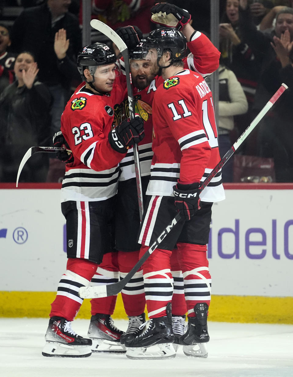 From left, Chicago Blackhawks center Philipp Kurashev, left wing Nick Foligno and right wing Taylor Raddysh celebrate Foligno's goal against the Minnesota Wild during the second period of an NHL hockey game, Wednesday, Feb. 7, 2024, in Chicago. (AP Photo/Erin Hooley)
