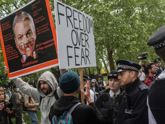 Police speak to a protester as conspiracy theorists gather at Hyde Park Corner on 16 May (Getty)