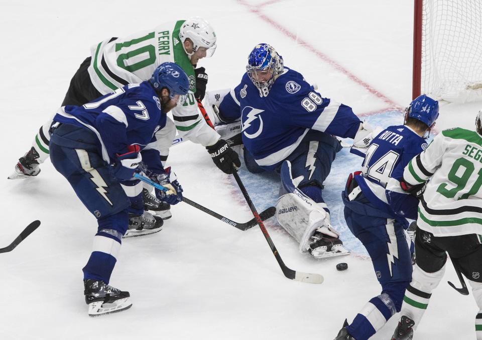 Dallas Stars right wing Corey Perry (10) scores on Tampa Bay Lightning goaltender Andrei Vasilevskiy (88) during the second overtime in Game 5 of the NHL hockey Stanley Cup Final, Saturday, Sept. 26, 2020, in Edmonton, Alberta. (Jason Franson/The Canadian Press via AP)