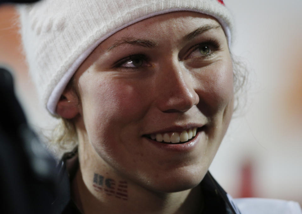 United States' Mikaela Shiffrin wears a temporary tattoo as she celebrates her gold medial win in the women's slalom at the Sochi 2014 Winter Olympics, Friday, Feb. 21, 2014, in Krasnaya Polyana, Russia. (AP Photo/Christophe Ena)