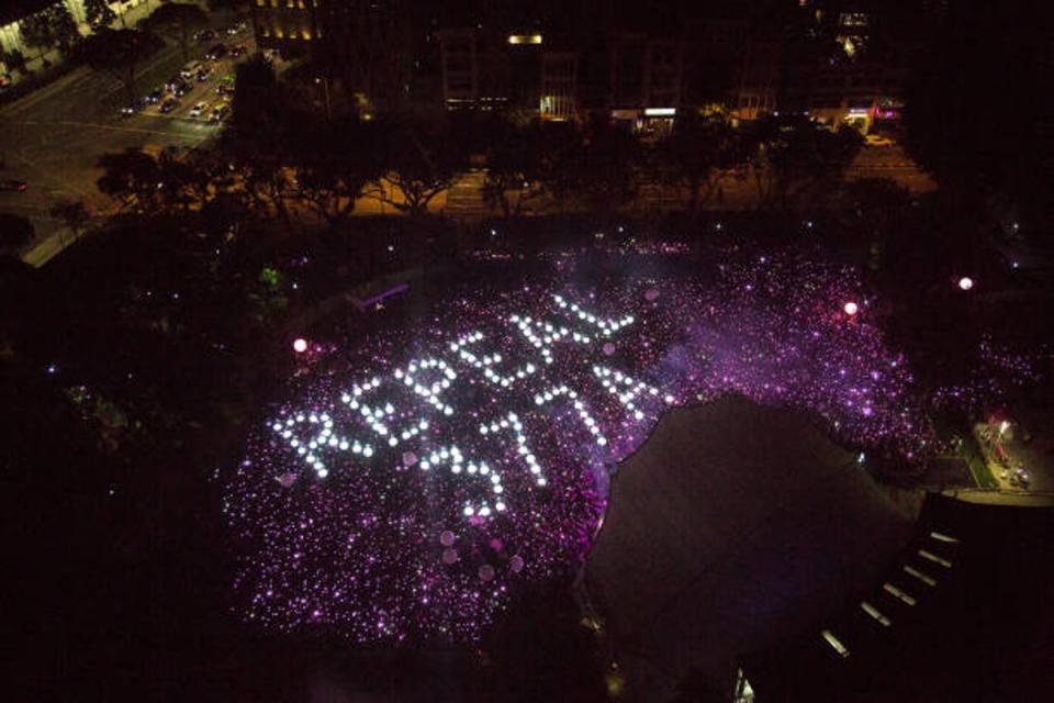 Attendees form the characters Repeal 377A in a call to repeal Section 377A of Singapore's Penal Code which criminalises sex between men during the Pink Dot event in 2019 (Getty Images)