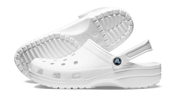 A pair of white Crocs clogs.