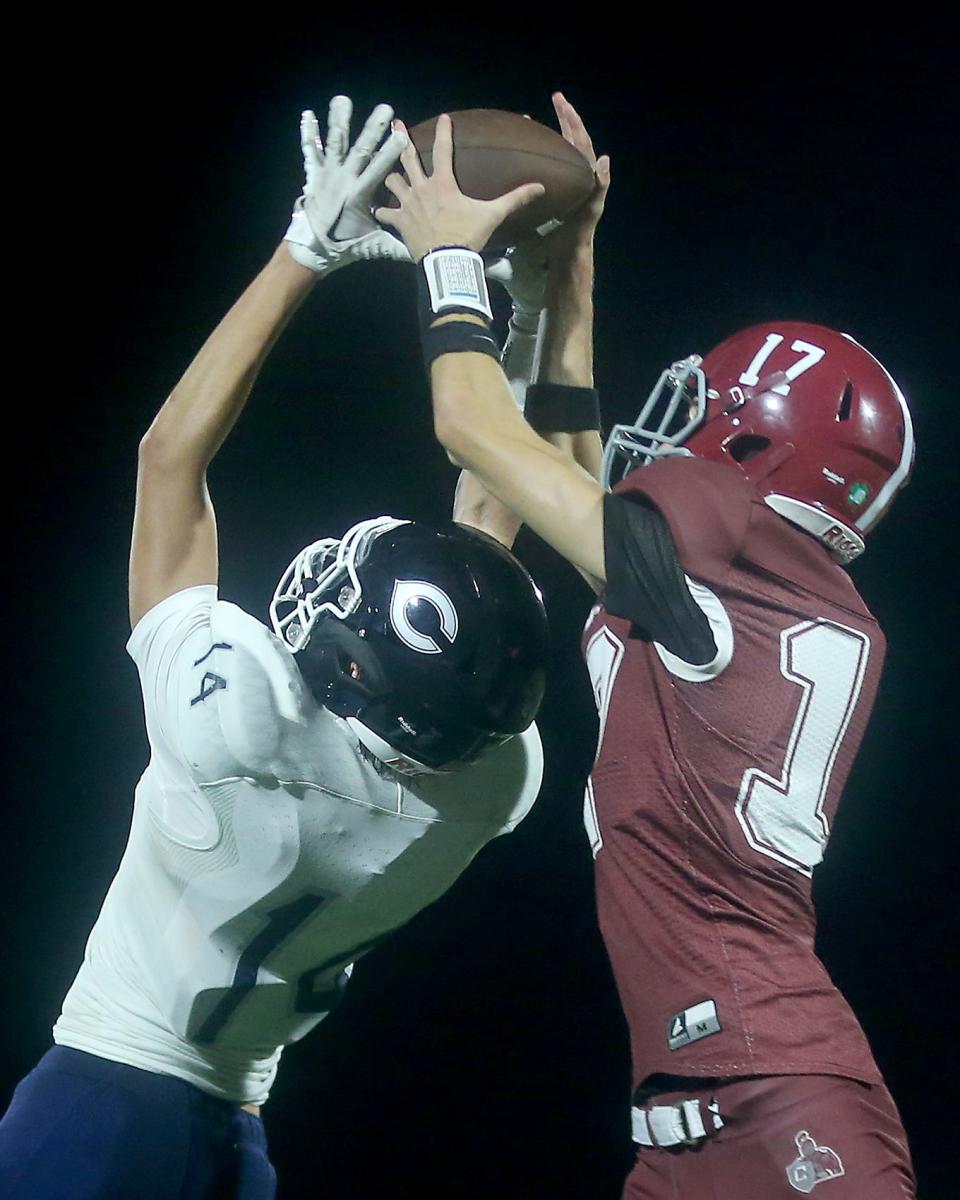 Carver’s Camren Allain grabs the interception over Cohasset's Will McLoughlin during fourth quarter action of their game at Carver Middle High School on Friday, Oct. 6, 2023. Carver would go on to win 42-39 in overtime.